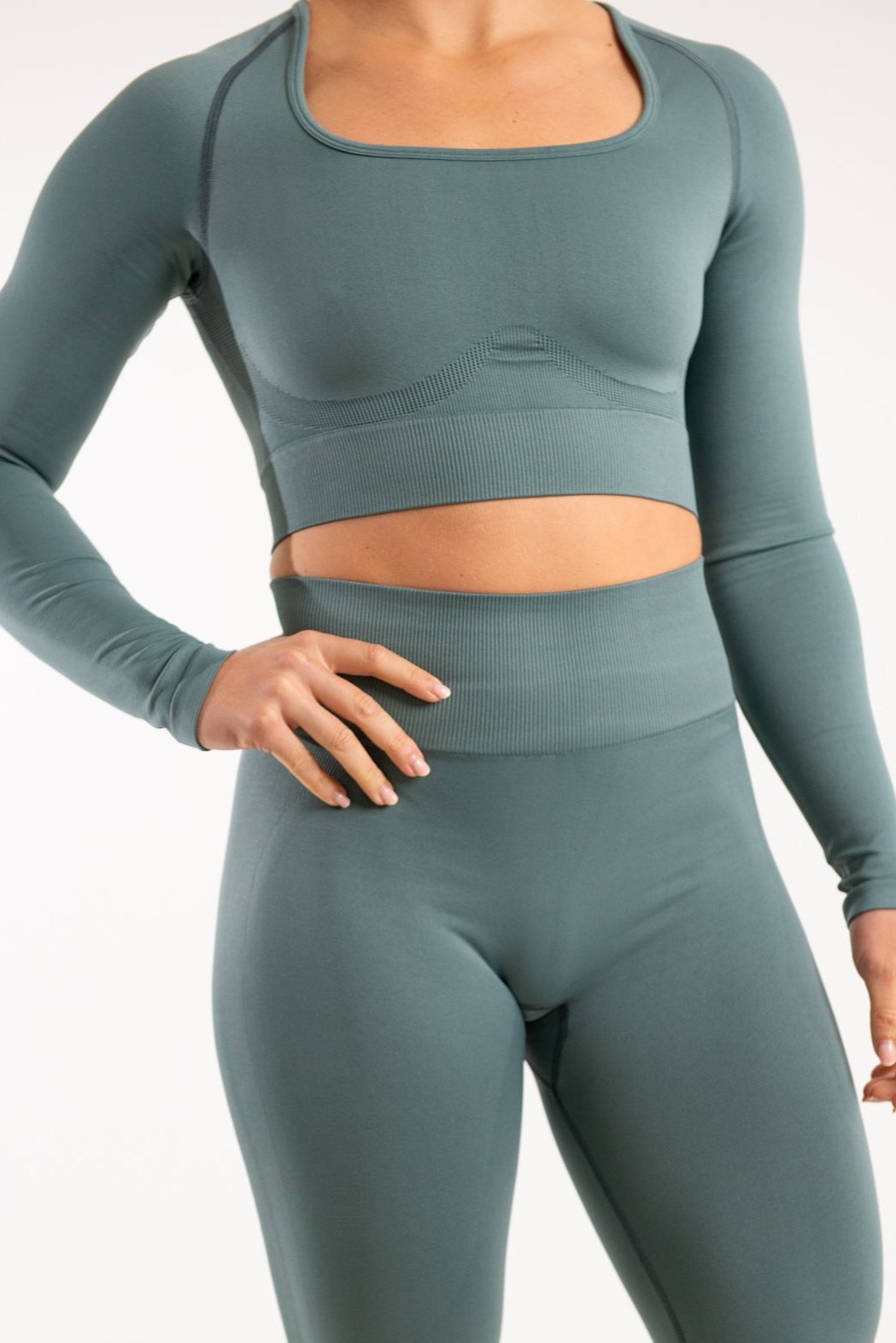 Model wearing Seamless Long Sleeve Top and Leggings posing with one hand on her hip