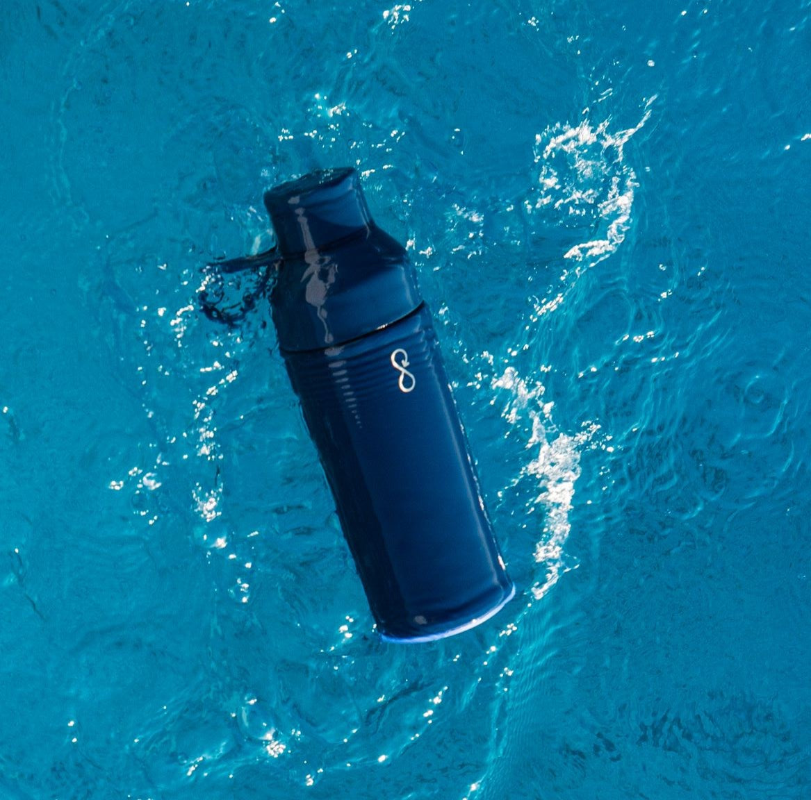 Navy Blue Pioneer Ocean bottle floating in the Ocean 