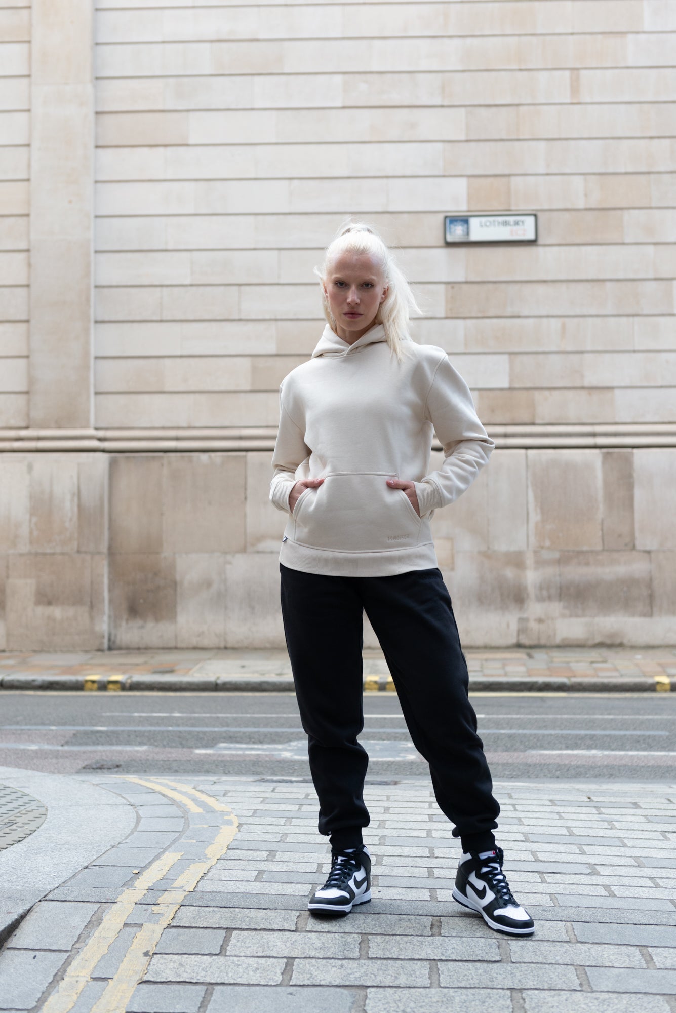 A Woman in luxury joggers and hoodie made from organic cotton and sustainable materials 