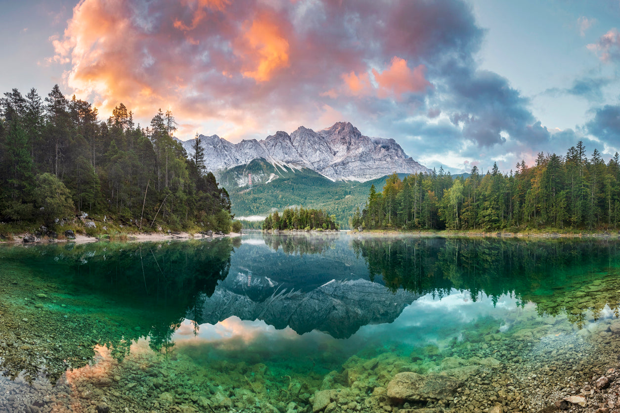 Image of lake with the forest and mountains in the background